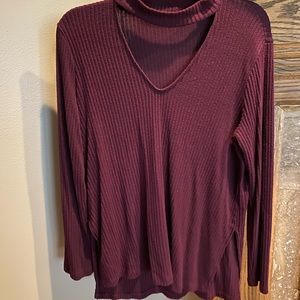 Maroon sweater with choker neckline and small cuts on the side